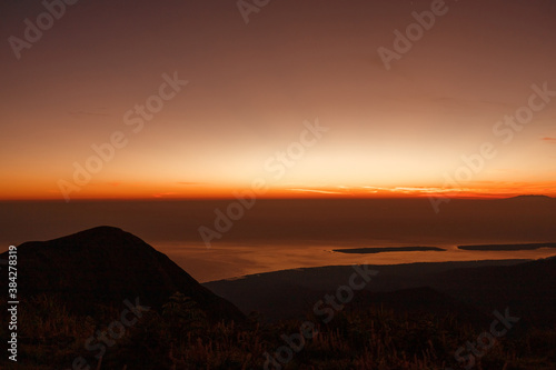 Beautiful view sunrise and foggy landscape from top of mountain in the morning at Rinjani National Park, Lombok, Indonesia