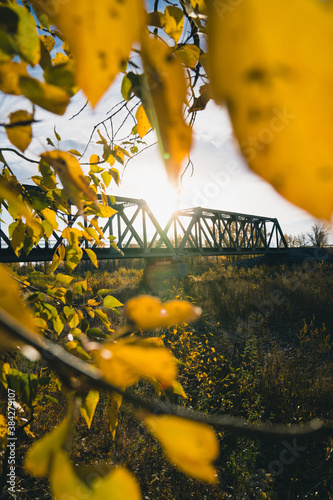 Maintenance Trains Crossing Truss Bridge in Autumn