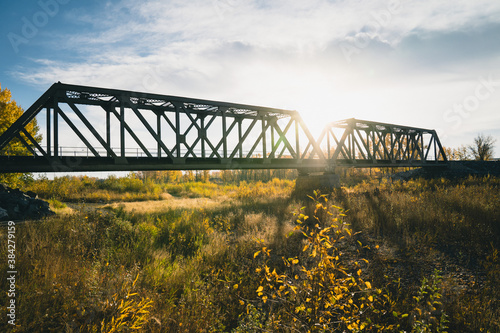 Maintenance Trains Crossing Truss Bridge in Autumn