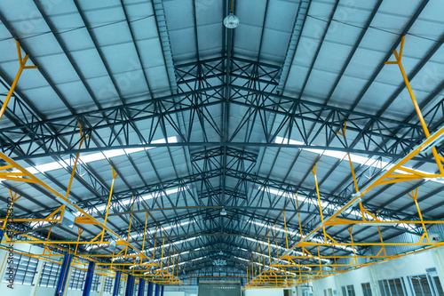 Warehouse metal roofing of car showroom Large steel roof structure bottom view with skylight translucent roof. translucent roof structure in construction site..