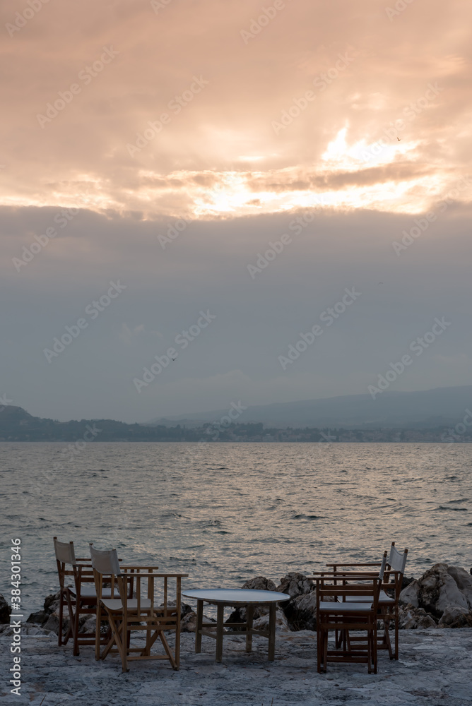 Small tables of a restaurant by the Greek sea Small tables of a restaurant by the Greek sea