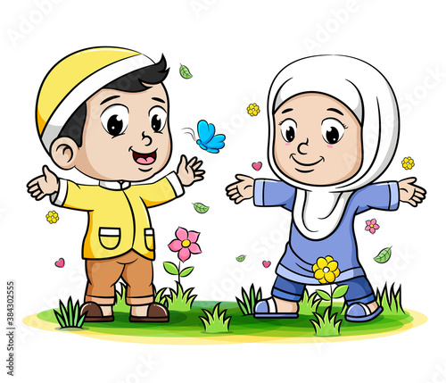 Boy and girl Muslim Kids playing with butterfly in the park