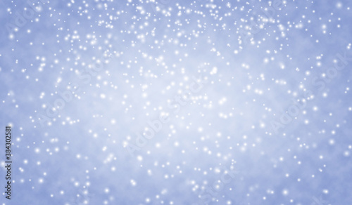 Beautiful blue Christmas background with falling snowflakes. Snowfall sky. Christmas and New Year winter background.