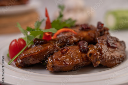 Chili Paste Fried Chicken Wings in White Platter with Chili and Coriander