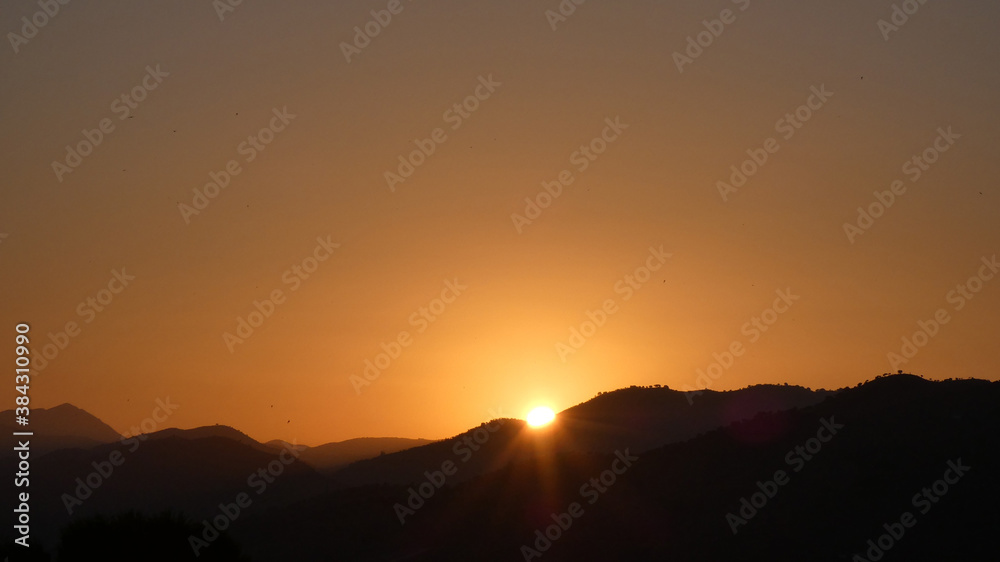 Sun rising over hills in southern Andalusia