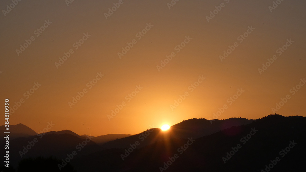Sun rising over hills in southern Andalusia Sun rising over hills in southern Andalusia