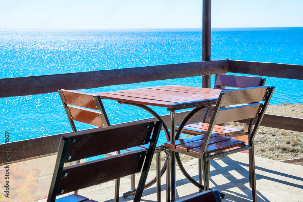 Fototapeta premium Table and chairs by the sea