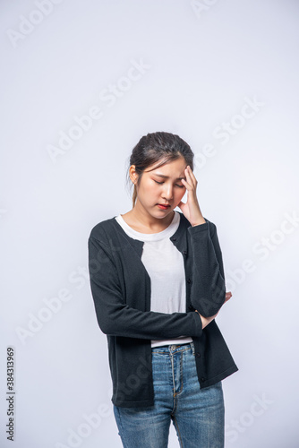 A sick woman with a headache and put her hand on her head