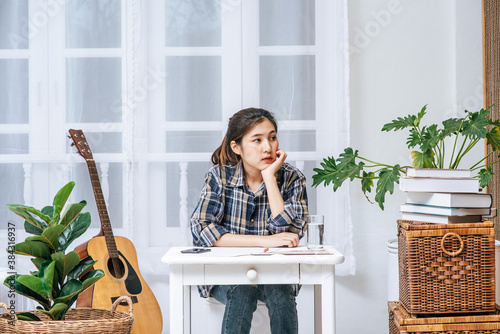 A woman sitting at a desk analyzes the document and is stressed. photo