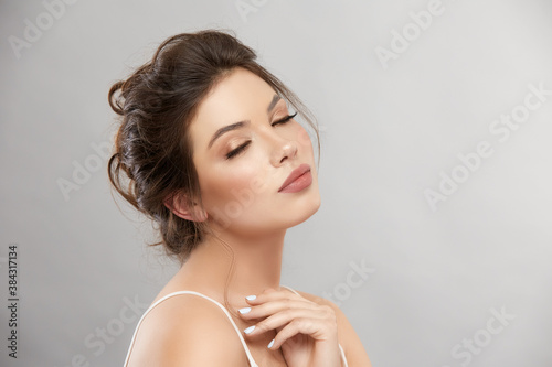 sensetive beautiful woman with eyes closed on grey