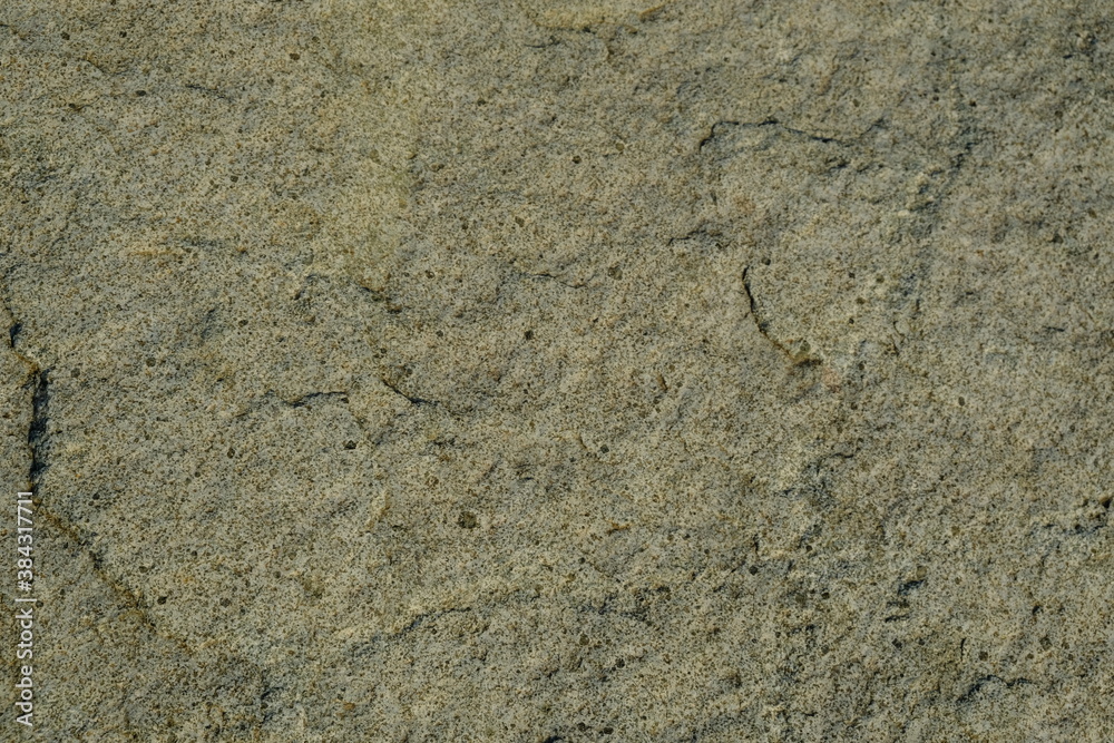 Background from a stone of igneous rock. Wallpaper made of textures of boulders of volcanic origin. Surface of granite, diabase, gabbro interspersed with spar, quartz. Sea shore. Day. Georgia. Background from a stone of igneous rock. Wallpaper made of textures of boulders of volcanic origin. Surface of granite, diabase, gabbro interspersed with spar, quartz. Sea shore. Day. Georgia.