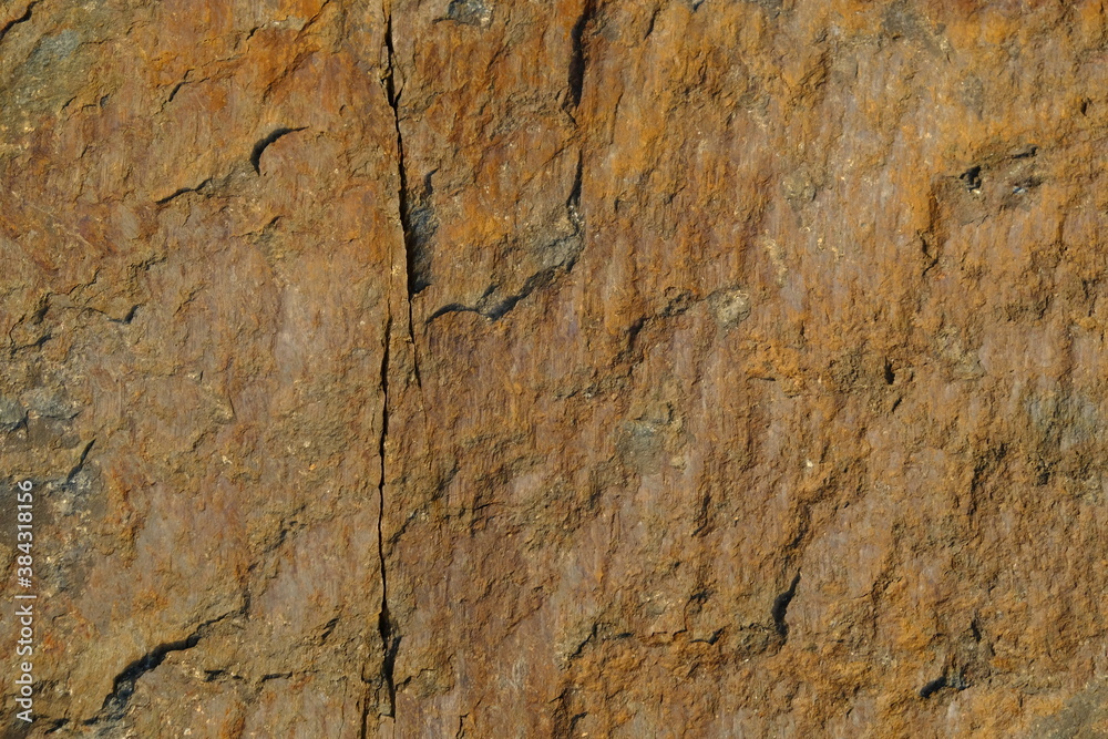 Background from a stone of igneous rock. Wallpaper made of textures of boulders of volcanic origin. Surface of granite, diabase, gabbro interspersed with spar, quartz. Sea shore. Day. Georgia. Background from a stone of igneous rock. Wallpaper made of textures of boulders of volcanic origin. Surface of granite, diabase, gabbro interspersed with spar, quartz. Sea shore. Day. Georgia.
