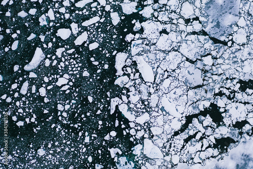 Obraz na płótnie Nature wallpaper of cracked and thawed glaciers ice, floes floating on the water of ocean. w salonie