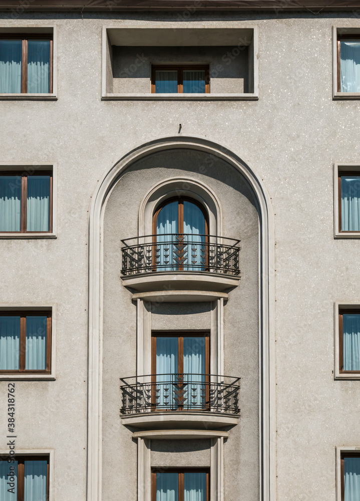 A mix of old and new architecture. Facade of a building with windows and balconies