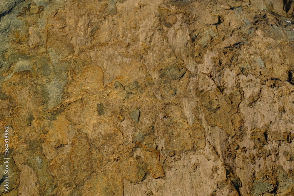 Background from a stone of igneous rock. Wallpaper made of textures of boulders of volcanic origin. Surface of granite, diabase, gabbro interspersed with spar, quartz. Sea shore. Day. Georgia. Background from a stone of igneous rock. Wallpaper made of textures of boulders of volcanic origin. Surface of granite, diabase, gabbro interspersed with spar, quartz. Sea shore. Day. Georgia.