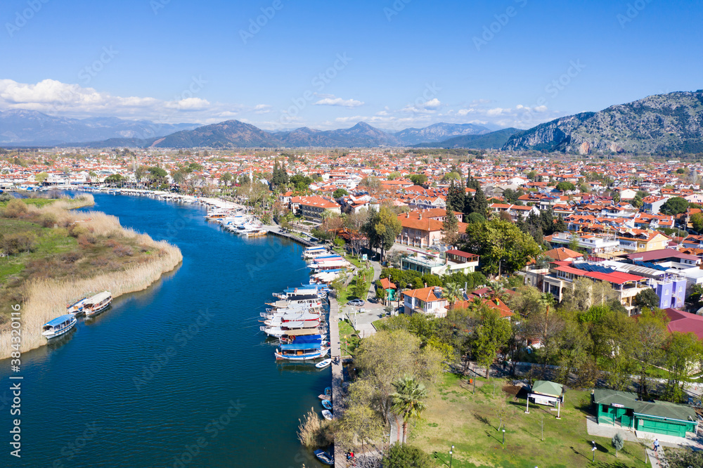 Dalyan canal view and settlement, excursion bout tour on Dalyan river valley. Dalyan is popular tourist destination in Turkey. Aerial view from drone.