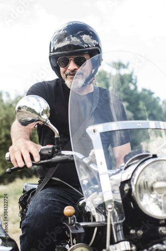 Mature with sunglasses man on sidecar looking at camera