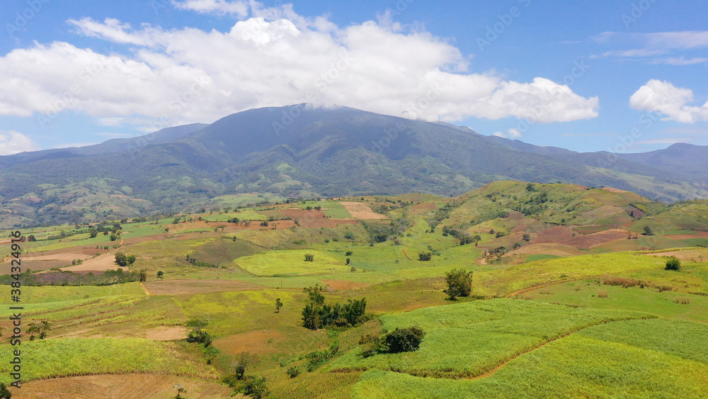 Farm and agricultural land with crops in the mountainous area of the island of Mindanao, Philippines, view from above.
