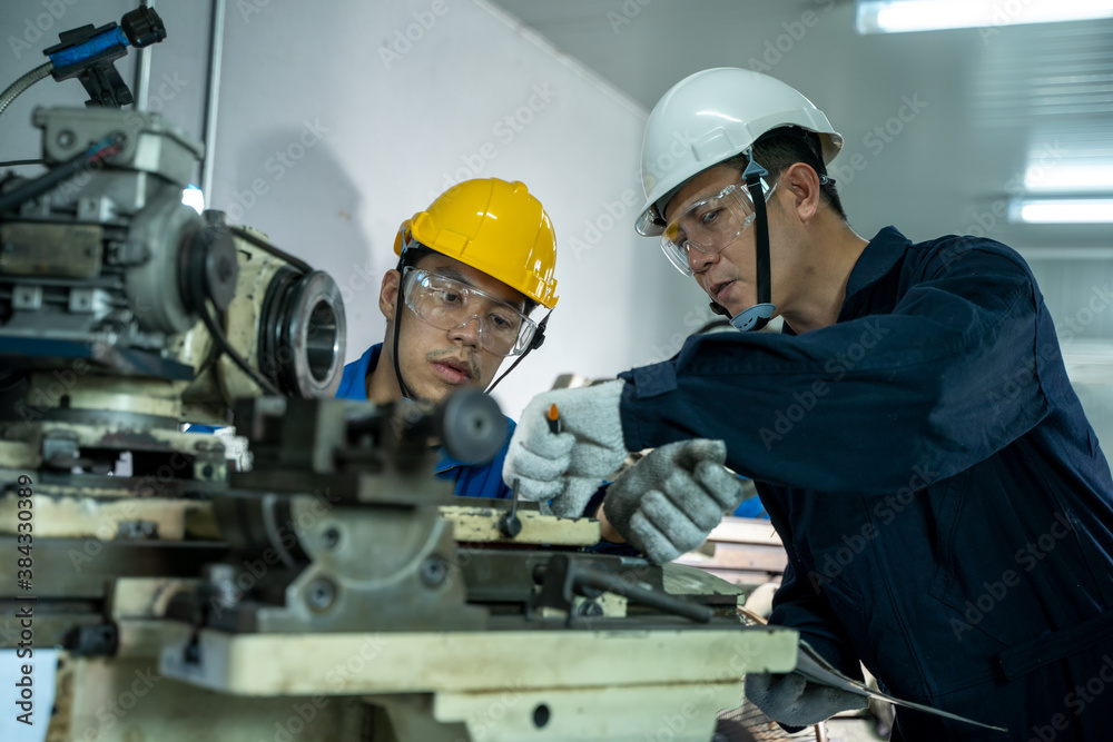 Engineer and factory worker are working on projects at machine for steel structure industry. Engineer and factory worker are working on projects at machine for steel structure industry.