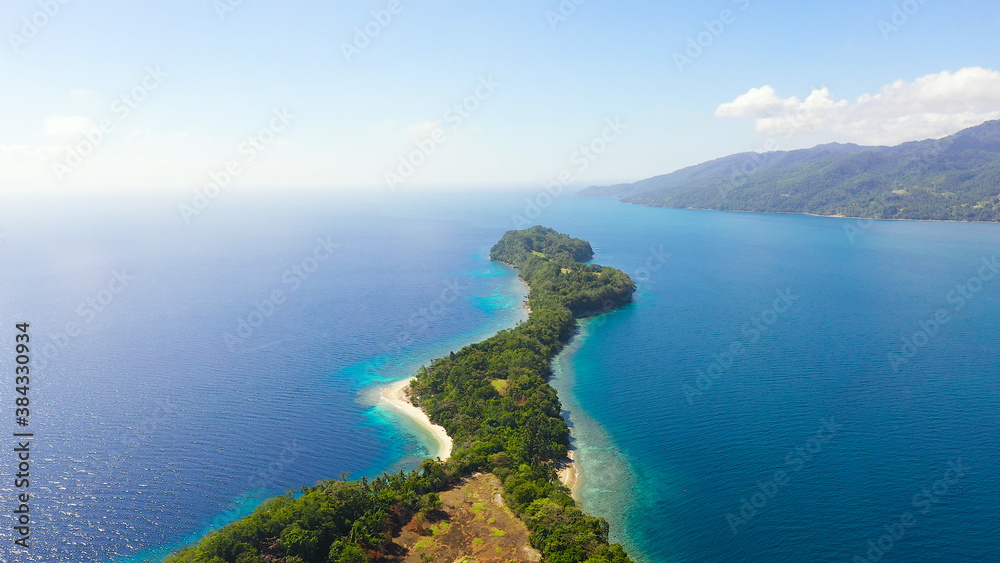 Aerial view of Big Liguid Island with sand beach, palm trees by atoll with coral reef. Big Cruz Island, Philippines, Samal.