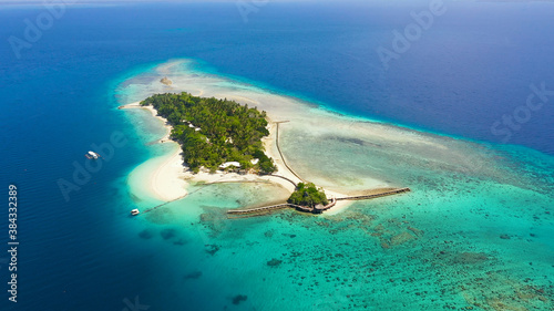 Aerial view of sandy beach on a tropical Little Liguid Island with palm trees. Little Cruz Island, Philippines, Samal.