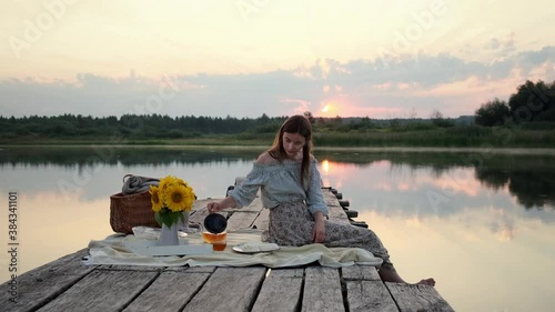 Happy Girl Have a Breakfast on the Pier at the Morning Sunrise on the Lake. Hot Tea, Teapot and Sweets Happiness or Inspiration Concept, Enjoy Life