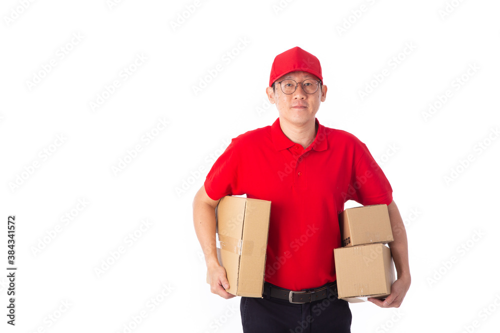young Asian delivery man in red uniform, carry cardboard box in hands isolated on white background. young Asian delivery man in red uniform, carry cardboard box in hands isolated on white background.