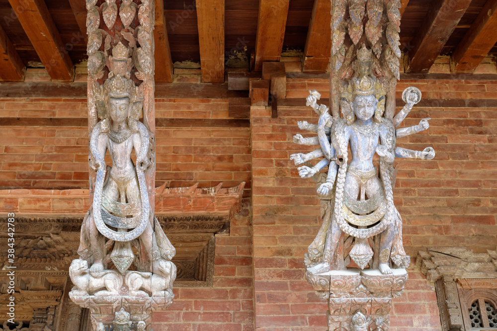 Many arms statue on a carved wooden roof strut, Mul Chowk, Hanuman Dhoka Royal Palace, Patan Durbar Square, Unesco World Heritage Site, Kathmandu valley, Lalitpur, Nepal, Asia