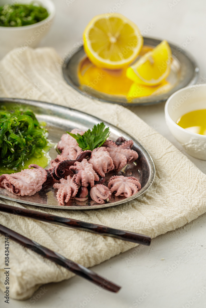 Traditional asian food. Delicious boiled octopus with fresh wakame salad.