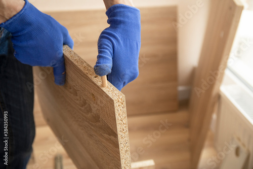 Professional carpenter master assembling the furniture