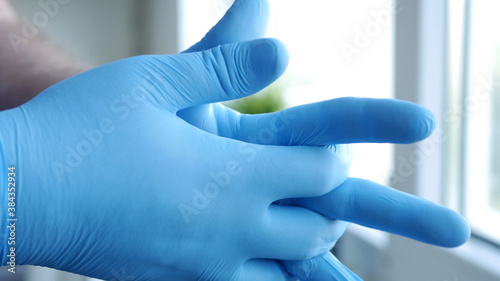 Image with Doctor Hands Wearing Surgical Gloves Needed in Protection Against Coronavirus Contamination