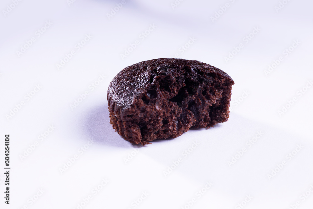 a half of plain dark chocolate cupcakes on white background
a half of plain dark chocolate cupcakes on white background