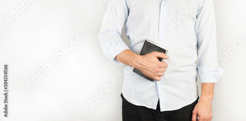 Bible book in hand. The man in the shirt. Preacher