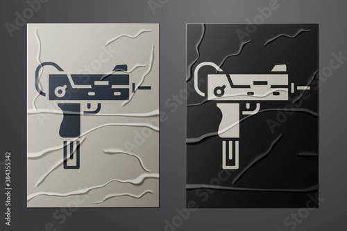 White UZI submachine gun icon isolated on crumpled paper background. Automatic weapon. Paper art style. Vector.