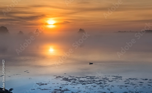Sunrise with the mist above a river, or lake colorful summer landscape, Easte...