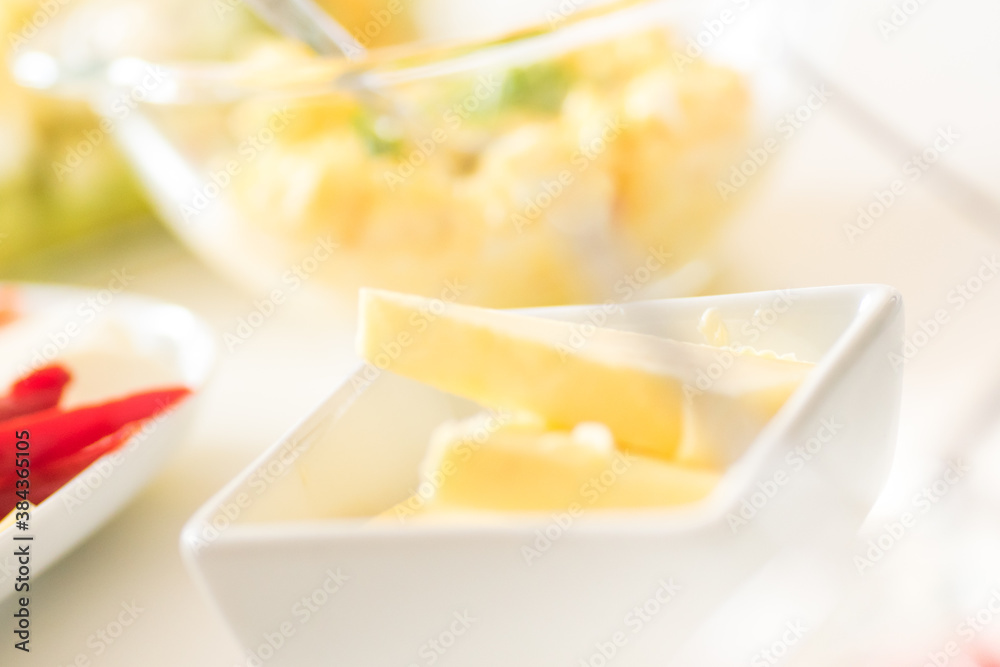 Breakfast table - butter, egg and mayo sandwich filling, sliced peppers