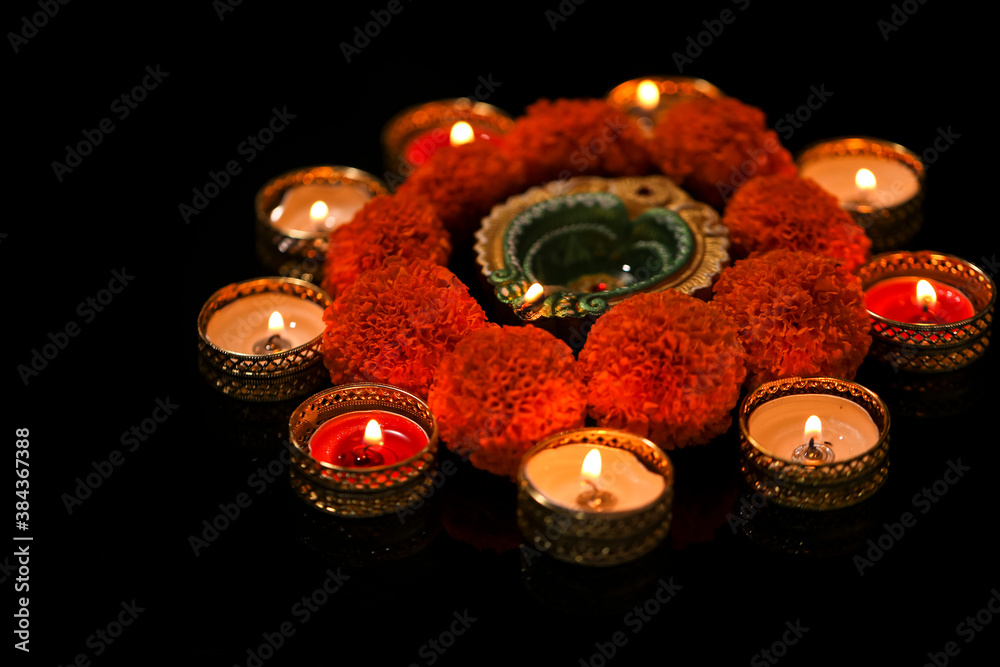 Indian Festival Diwali , oil lamp and flower design on dark background Indian Festival Diwali , oil lamp and flower design on dark background
