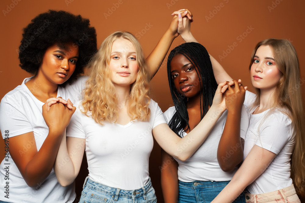 young pretty asian, caucasian, afro woman posing cheerful together on brown background, lifestyle diverse nationality people concept young pretty asian, caucasian, afro woman posing cheerful together on brown background, lifestyle diverse nationality people concept