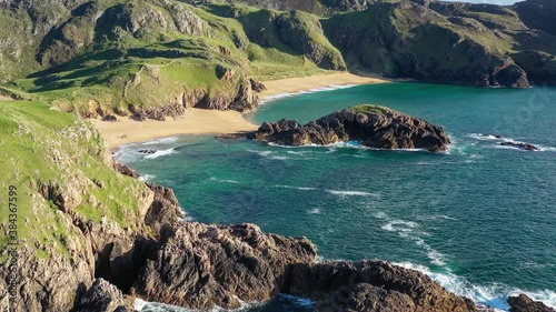 Boyeeghter Bay, commonly known as Murder Hole Beach, is one of the most beautiful beaches in Ireland situated on the Melmore Head Peninsula in County Donegal. Majestic Atlantic waves on sandy beaches photo