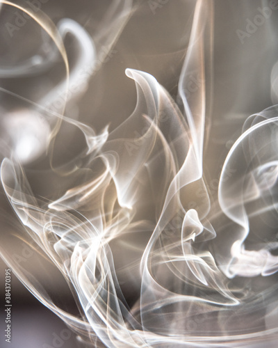 Trail of smoke on a dark background - creative colour effects with smoke smudges