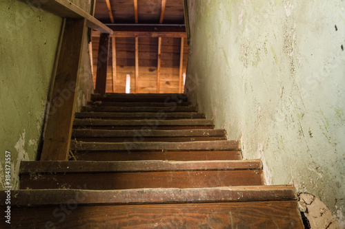Creepy wooden stairs going up in an abandoned house in the deep south