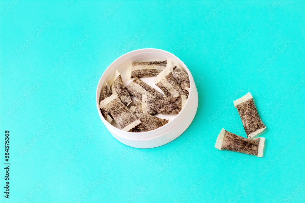 Round box with snus. Cigarette substitute, nicotine pouches. Round box with snus. Cigarette substitute, nicotine pouches.
