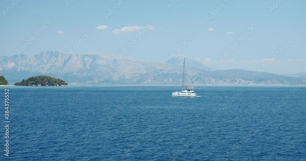 Catamaran yacht boat sailing in open ionian sea. Luxury summer travel concept Catamaran yacht boat sailing in open ionian sea. Luxury summer travel concept