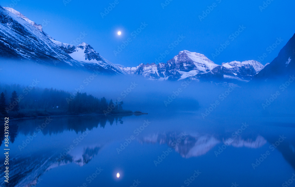 Blue Light and Lake Mirror of Moon, Clouds and Mountains of Glacier National Park