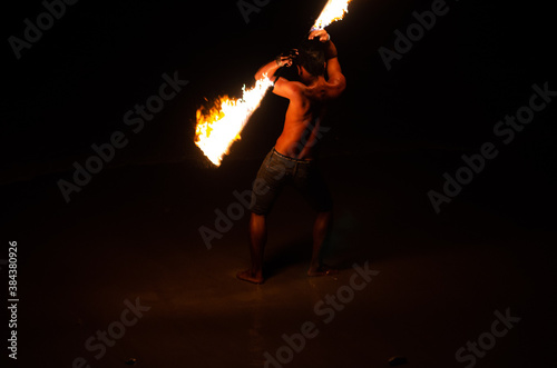 Man doing Fire Show at a beach bar