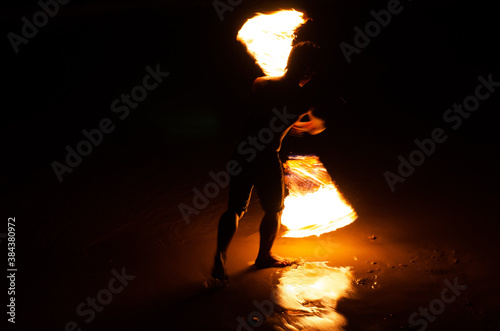 Man doing Fire Show at a beach bar