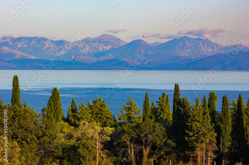 panoramic view of corfu island, mountains and sea with cypress and olive trees  © William Richardson