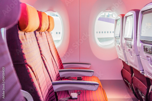 Empty seat rows in an airplane cabin.