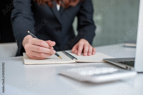 Businessman are taking notes at work to summarize business proposals, financial success, certified accounting concepts