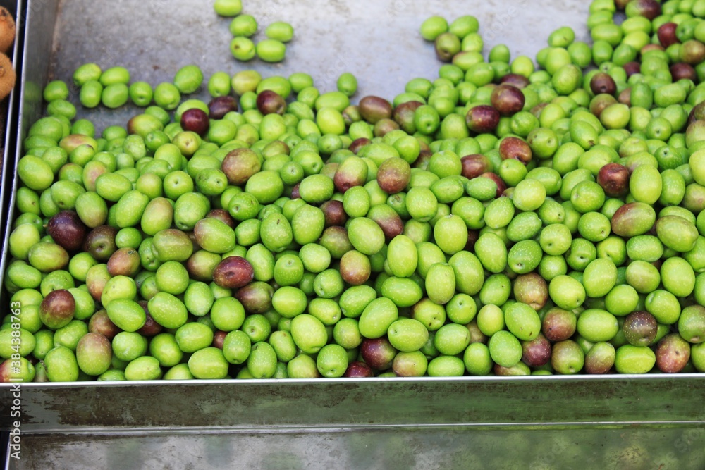 Stall with green olives from Volos at street market in Athens, Greece.